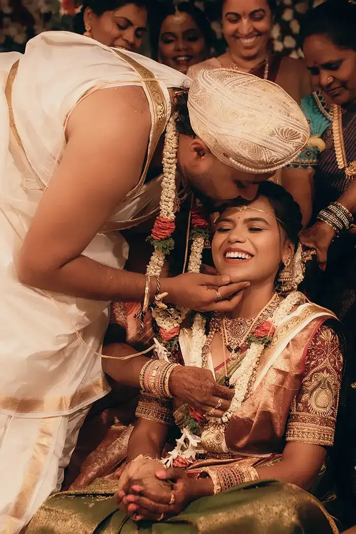Groom kisses happy bride during wedding ceremony.